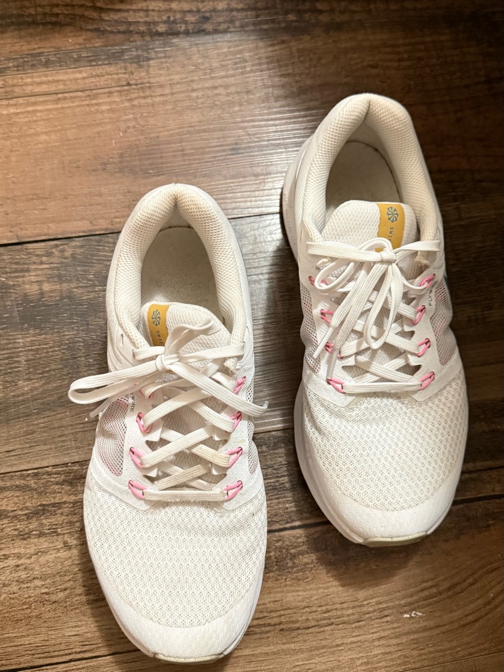 Nike Women’s White Athletic Sneakers with Pink Eyelet Details